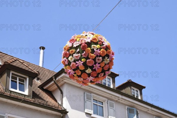 Ettlingen, Germany - August 13th 2025: Floral sphere of flowers hanging above street as summer