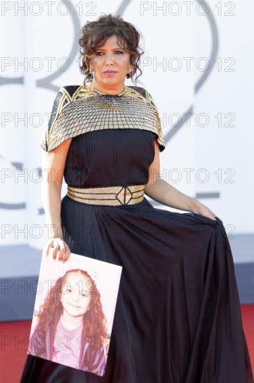 Venice, Italy - 3 September 2025: Kaouther Ben Hania with a portrait of five-year-old Palestinian