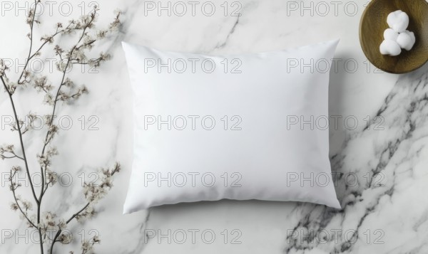 A white pillow sits on a marble countertop. The pillow is unmade and has a floral pattern on it.