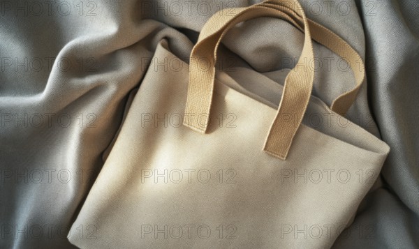 A tan purse with a brown strap sits on a grey cloth. The purse is open and the strap is visible. AI