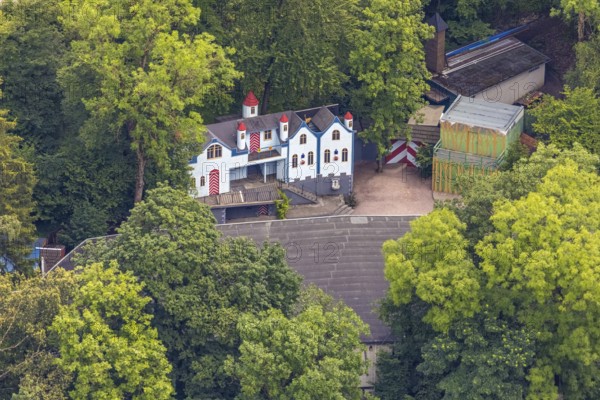 Aerial view, open-air stage covered by trees and neighbouring buildings with towers, Herdringen,