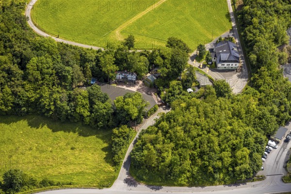 Aerial view, open-air stage covered by trees and adjacent buildings with towers, right playhouse of