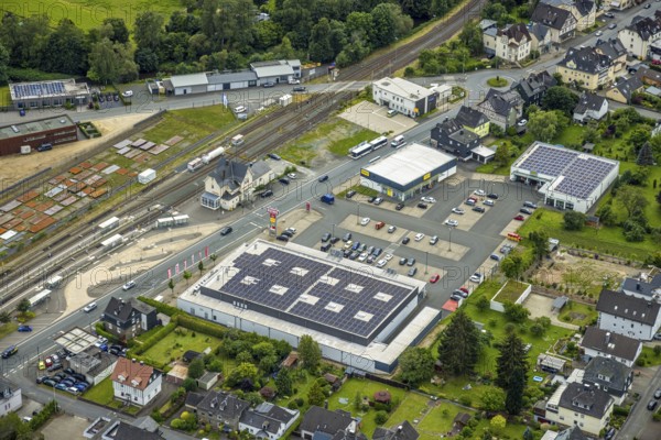 Aerial view, Bahnhofstrasse shopping centre with Rewe supermarket and solar roof, Takko fashion and