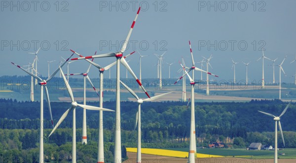 Aerial view, wind park and wind farm wind energy plant, wind turbines and rape fields near