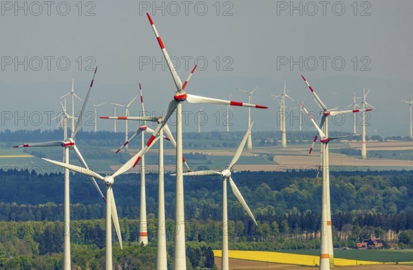 Aerial view, wind park and wind farm wind energy plant, wind turbines and rape fields near