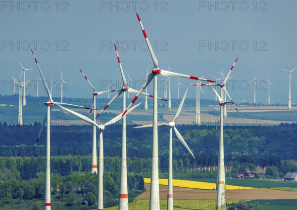 Aerial view, wind park and wind farm wind energy plant, wind turbines and rape fields near