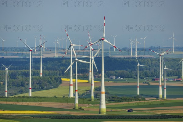 Aerial view, wind park and wind farm wind energy plant, wind turbines and rape fields near