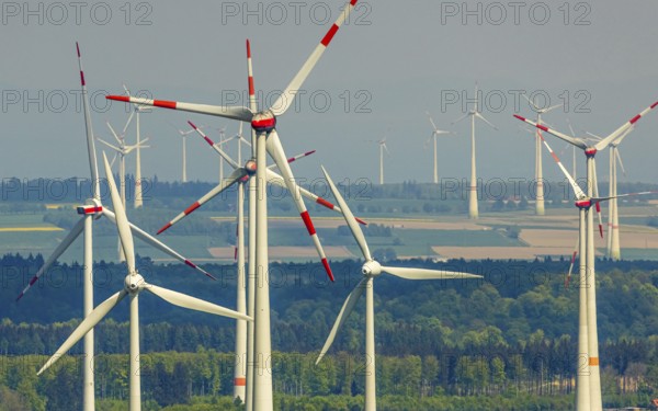 Aerial view, wind park and wind farm wind energy plant, wind turbines and rape fields near