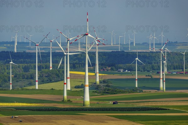 Aerial view, wind park and wind farm wind energy plant, wind turbines and rape fields near
