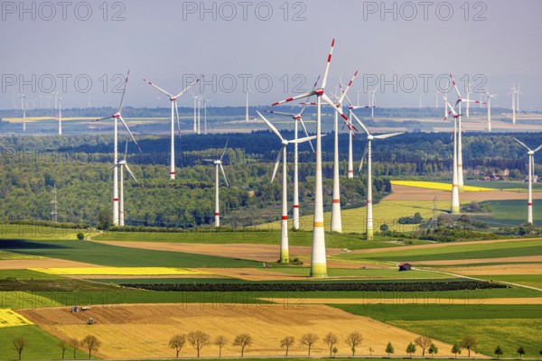 Aerial view, wind park and wind farm wind energy plant, wind turbines and rape fields near