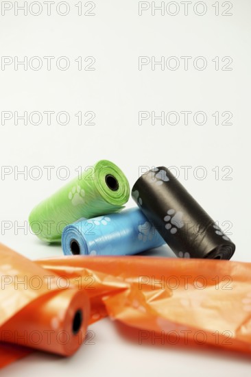 Rolls of biodegradable dog poop bags showing paw prints, promoting responsible pet ownership and