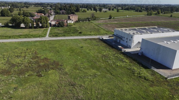 Modern industrial facility development in the Italian countryside showcasing infrastructure growth