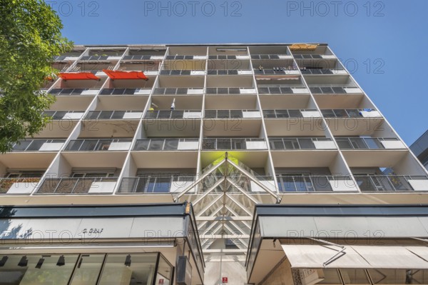 Concrete building with balconies and red awnings, Dornbirn, Vorarlberg, Austria