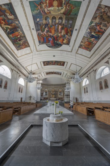The Roman Catholic parish church of St Martin, interior with altar, ceiling frescoes and baptismal