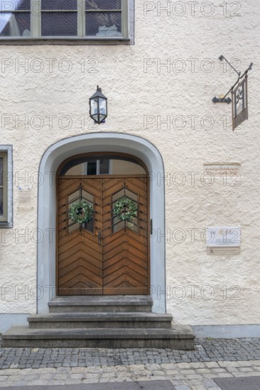 Façade with wooden gate, lantern and ivy wreaths, former residence of the patrician Vogt family,