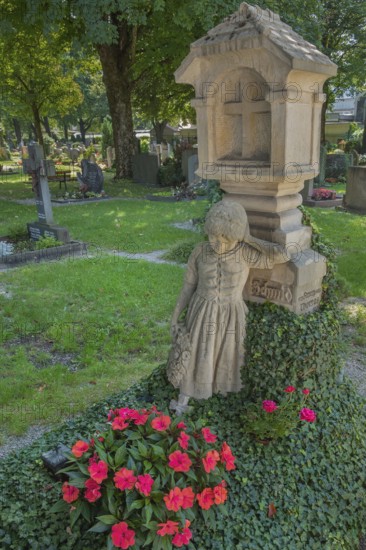 Gravesite with mourning girl figure, ivy and floral decoration, catholic cemetery, Kempten, Allgäu,