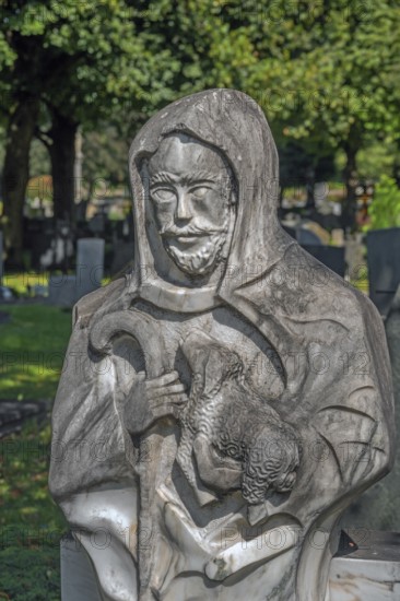 Gravesite with stone figure, the good shepherd with lamb catholic cemetery, Kempten, Allgäu,