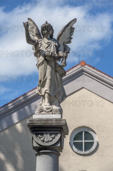 The angel on the fountain column by the funeral parlour, Catholic cemetery, Kempten, Allgäu,
