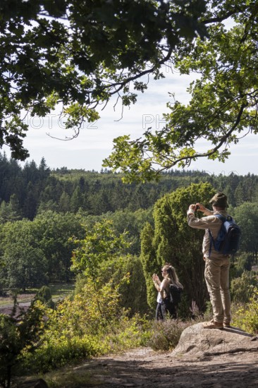 Viewpoint near the Totengrund, tourists taking photos, Lüneburg Heath near Wilsede, Bispingen,