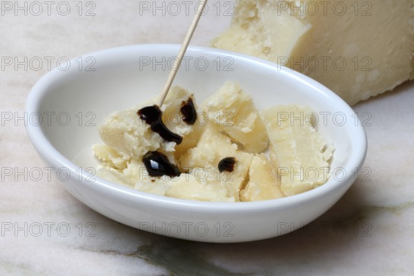 Parmesan cheese, pieces of cheese with crema di balsamico in small bowls