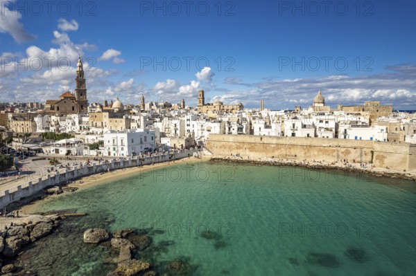 Old town of Monopoli with the cathedral, city walls and Cala Porta Vecchia beach seen from above,
