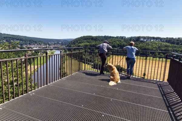 Dog walkers enjoy the view of the Weser from the Skywalk, Beverungen, Höxter, East Westphalia,