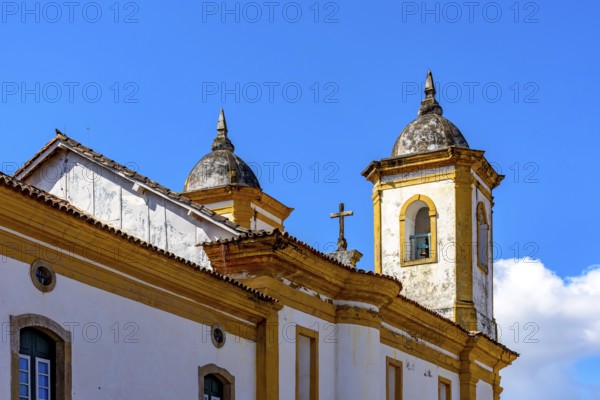 Tower and crucifix of a historic baroque church in the city of Ouro Preto in Minas Gerais, Ouro