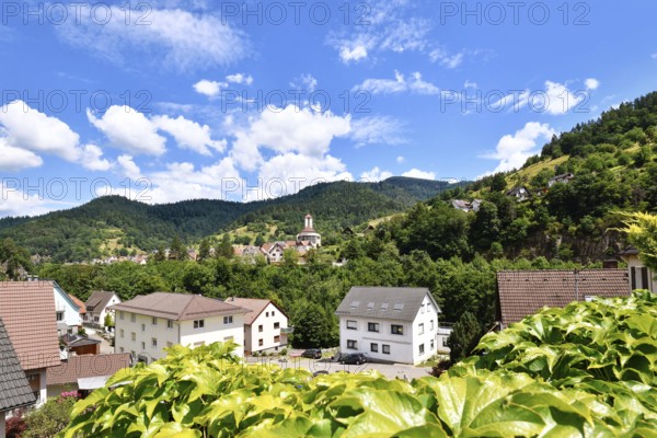 Forbach, Germany - July 12th 2025: Buildings surrounded by trees in Forbach. Scenic summer view of