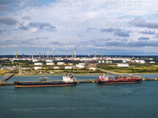 Gas tankers over refinery Esso Oil Terminal from drone, Southampton, Hampshire, England,