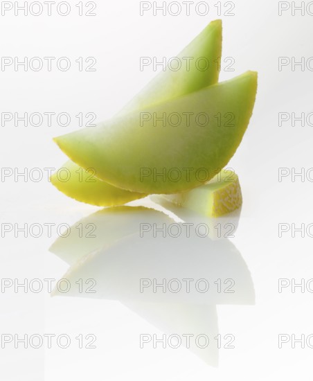 Honeydew melon, 3 melon slices against a white background