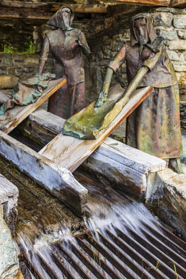 Copper sculptures of two washerwomen at the historic washing place, Saint Luc, Val d'Anniviers,