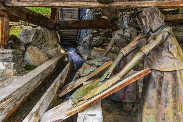 Copper sculptures of two washerwomen at the historic washing place, Saint Luc, Val d'Anniviers,