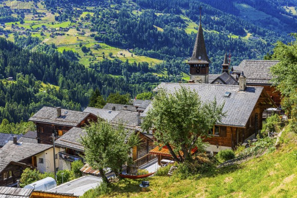 Houses with wooden shingle roofs, behind the church of Saint Anna, Ayer, Val d'Anniviers, Valais