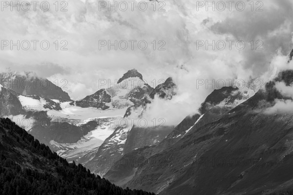 Four-thousand metre mountains and glaciers in clouds, black and white photograph, above Zinal, Val