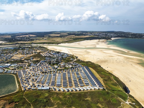 Holiday homes over Hayle Beach and Hayle Estuary from drone, St Ives Bay, Cornwall, England, United
