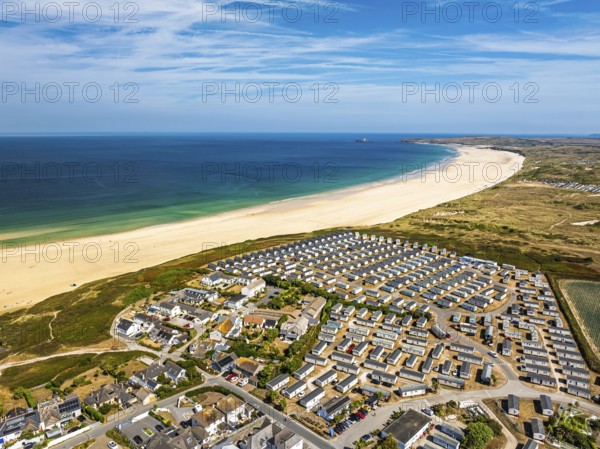 Holiday homes over Hayle Beach and Hayle Estuary from drone, St Ives Bay, Cornwall, England, United