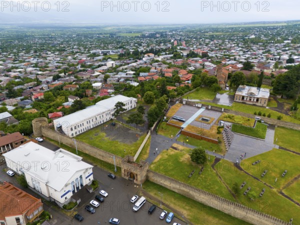 Historic walls and buildings with neighbouring trees in an urban environment, aerial view, bank