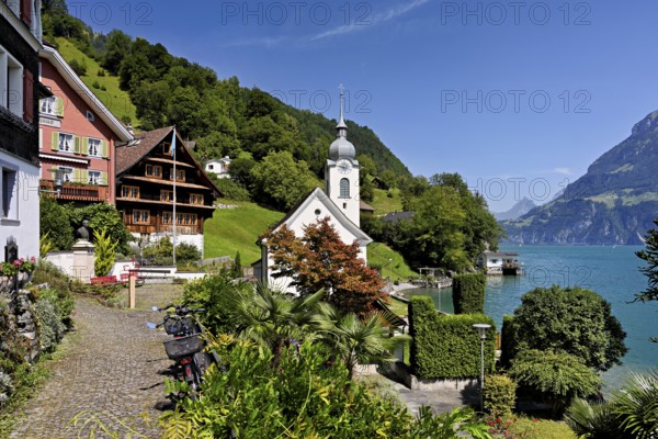 View of the village with the Roman Catholic Church of St Idda, Lake Lucerne in the background,