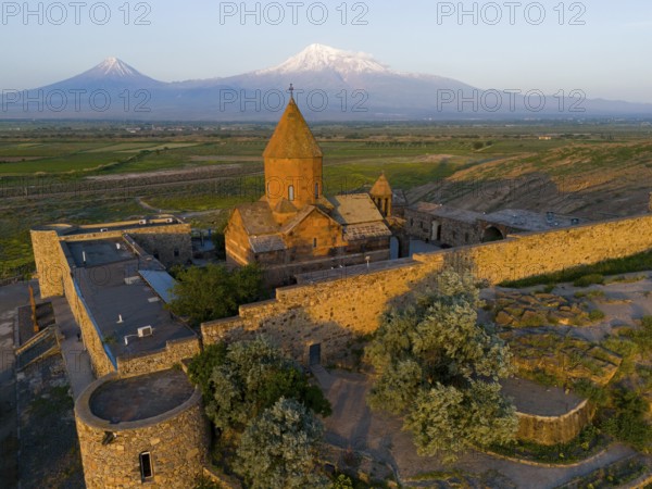 A historic monastery in the morning light in front of Mount Ararat, aerial view, Chor Wirap