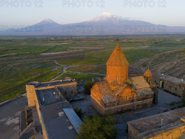 Historical monastery in the morning light with Mount Ararat in the background, aerial view,