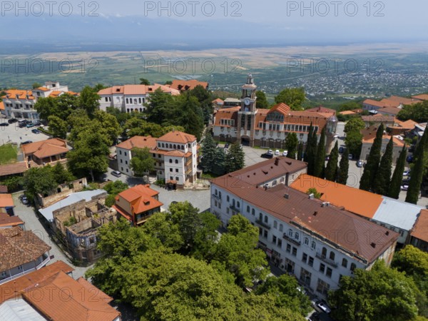 Panoramic view of a town with a prominent tower and traditional red roofs, aerial view, Sighnaghi,