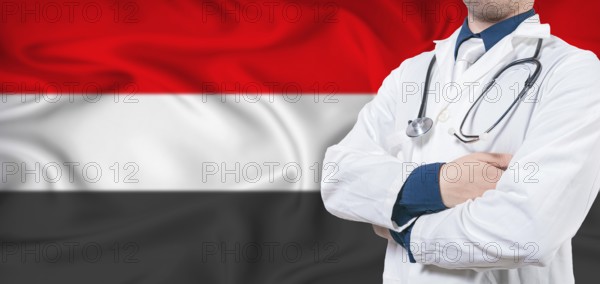 Yemen healthcare concept. Male doctor on Yemen flag. Doctor with crossed arms on Yemen flag