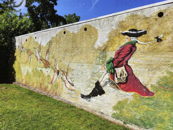 Painting on a wall Münchhausen on a duck hunt in the Münchhausen town of Bodenwerder,