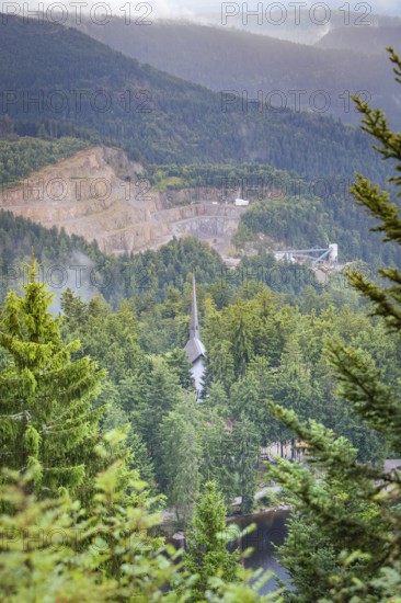 View over a wooded valley with mountain scenery and buildings between the trees, Mummelsee,