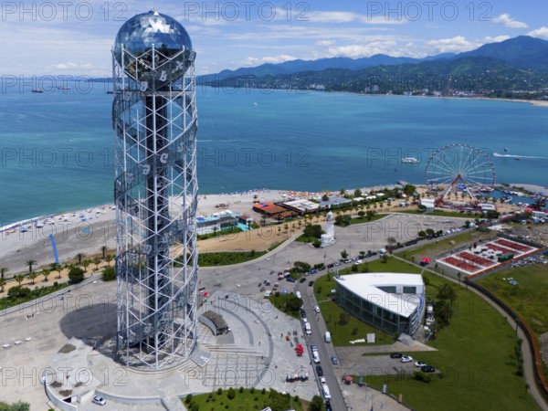 Steel construction tower overlooking the sea, Ferris wheel and surrounding coastline on a sunny