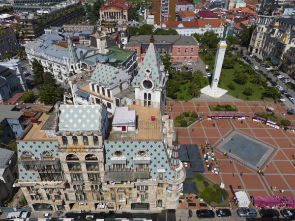 Detailed architecture with central square and green park, mountains in the background, aerial view,