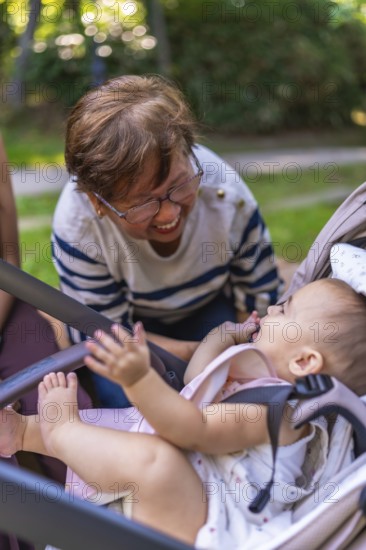 Grandmother enjoys a playful moment with her granddaughter, creating a heartwarming scene of family