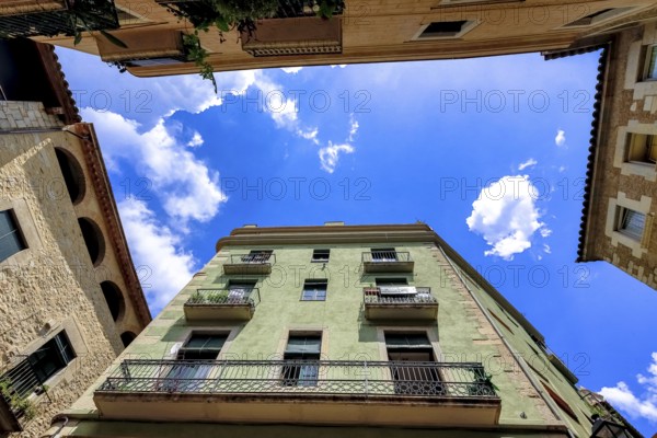 View into the sky between the alleys in the old town of Girona, Cataluña, Gerona, Catalonia, Spain,