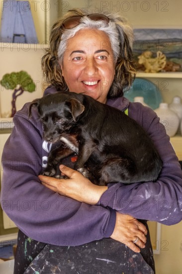 Sardinia, Pina Monne, woman portrait and dog on arm, artist, Tinnura, Europe, Oristano province,
