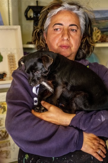 Sardinia, Pina Monne, portrait of woman and dog on arm, artist, Tinnura, Europe, Oristano province,